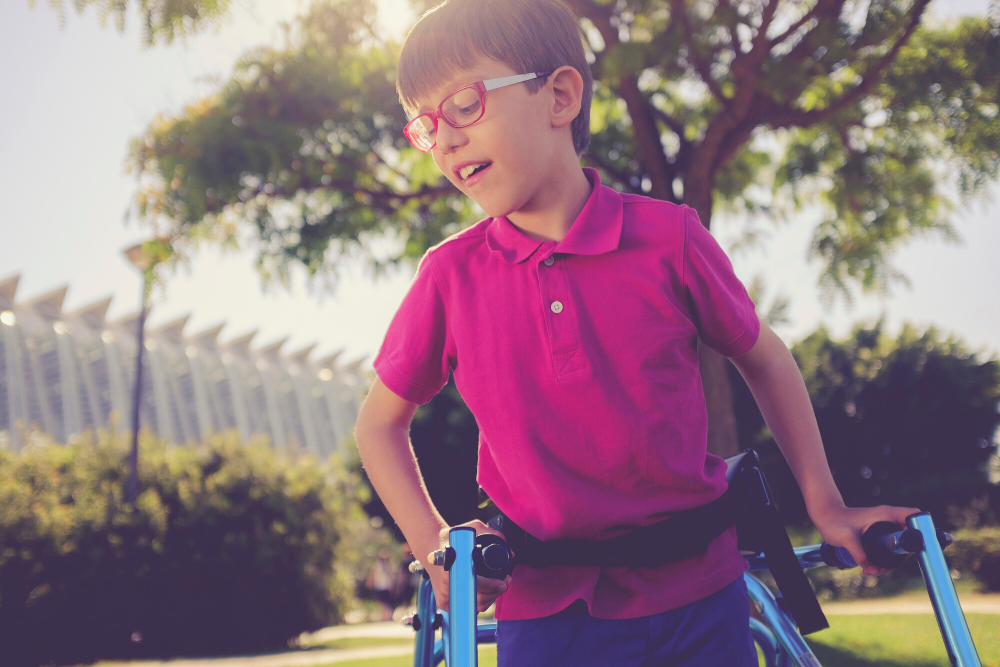child on walker in park