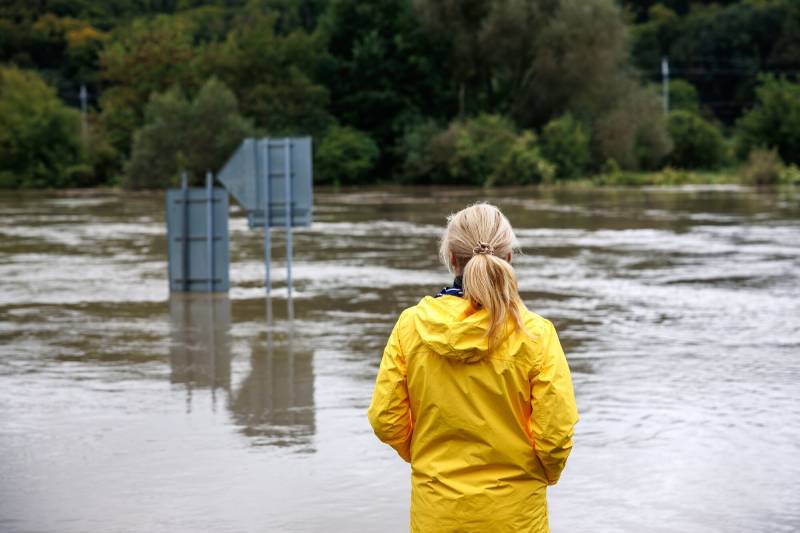 parent looking at flooded river