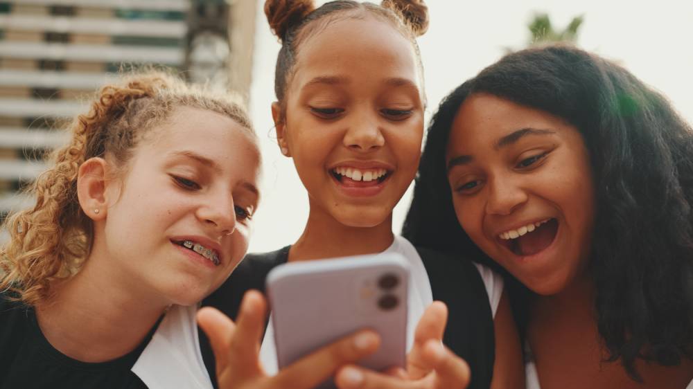 teens looking at phone