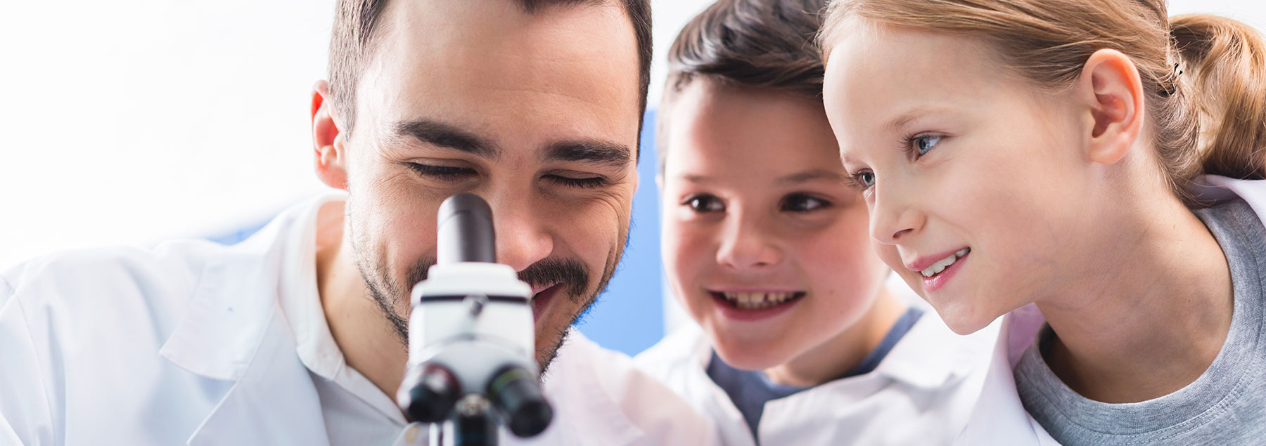 researcher with children in lab