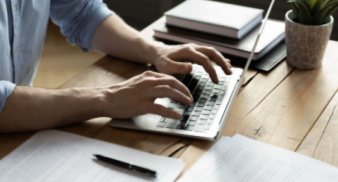 Student typing on laptop