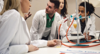 Phd students in science lab chatting