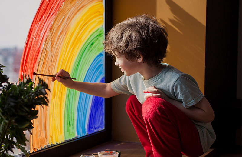 Child painting rainbow